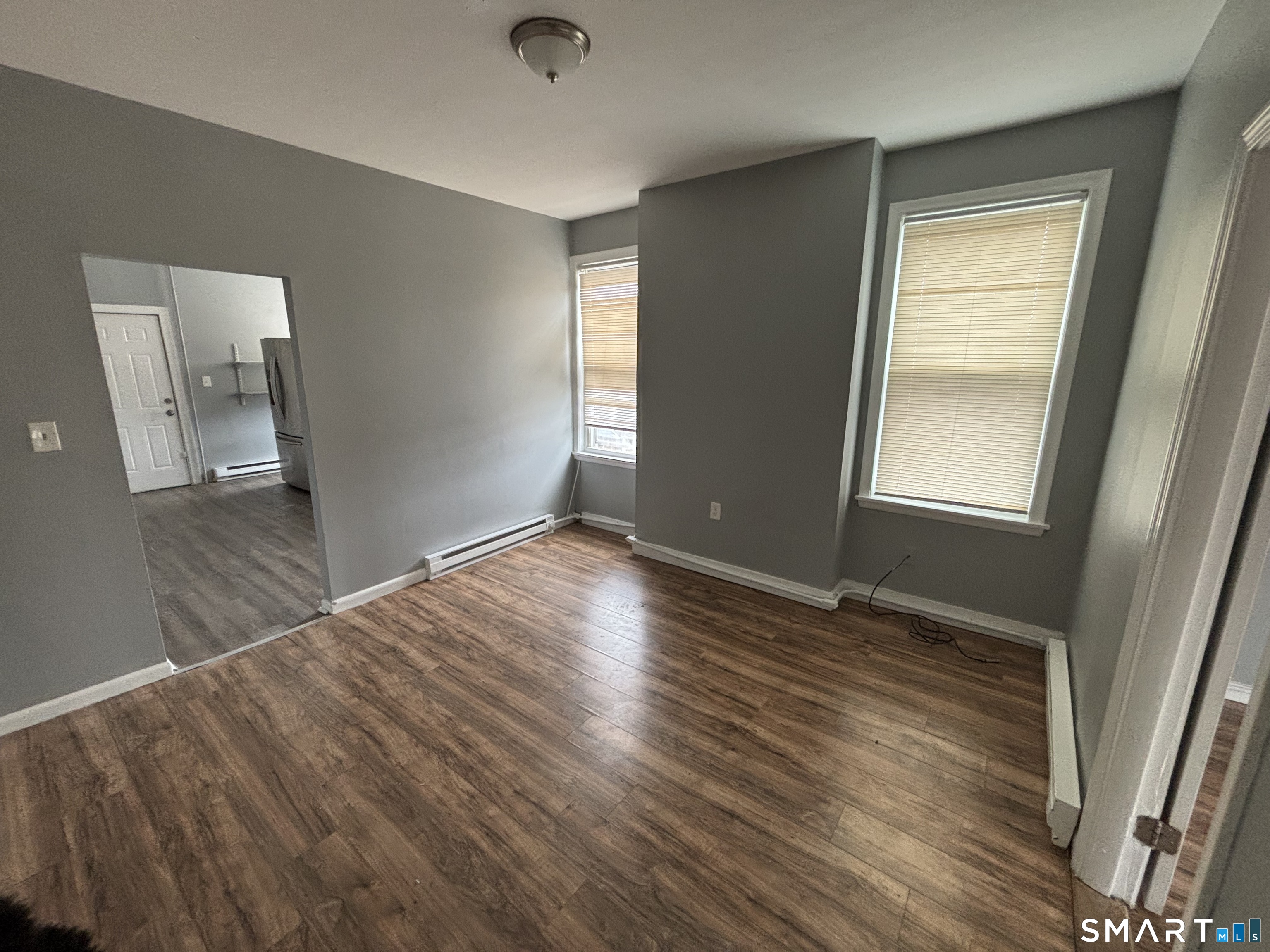 2370 Main Street Hartford, CT 06120 - Photo 2 of 7 an empty room with wooden floor and windows