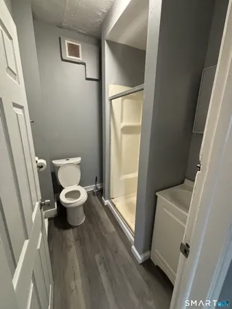 a bathroom with a toilet and a walk in closet