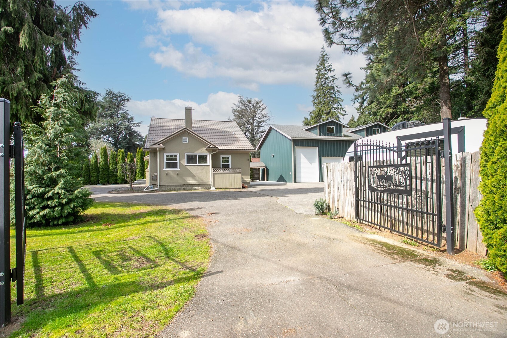 1082 West Smith Road Bellingham, WA 98226 - Photo 1 of 38 a front view of a house with a garden and swimming pool