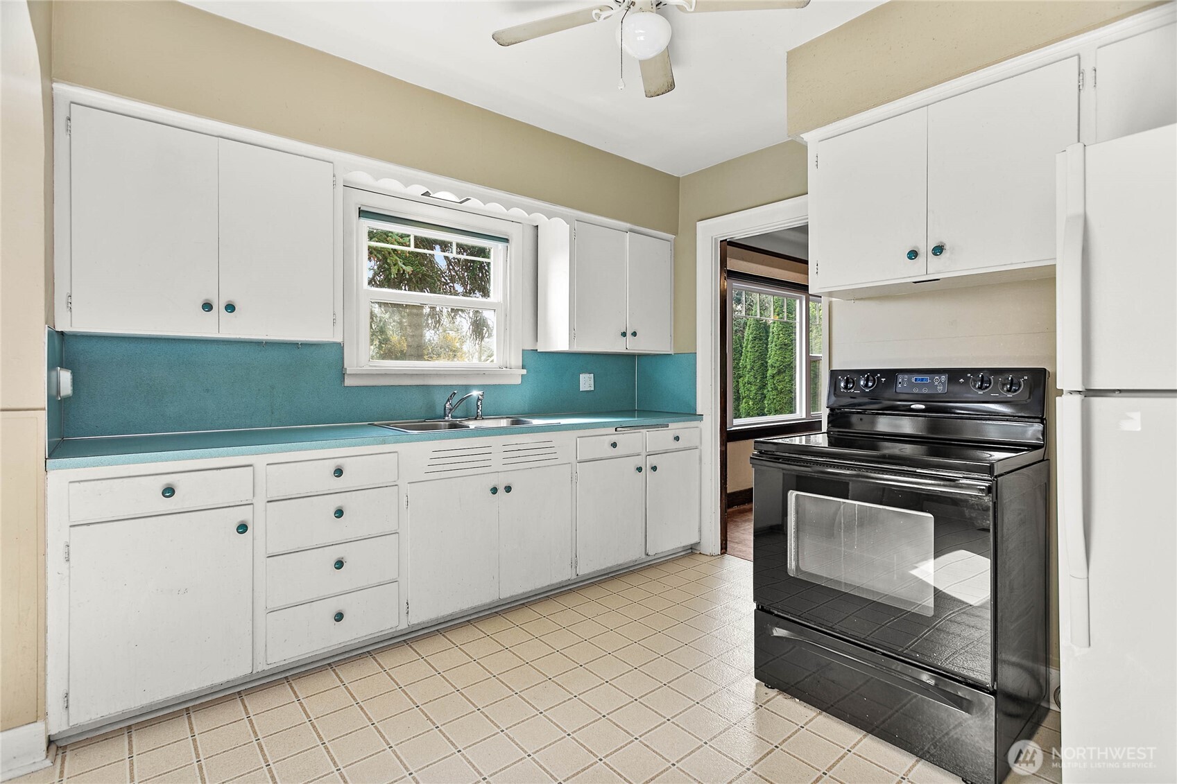 1082 West Smith Road Bellingham, WA 98226 - Photo 21 of 38 a kitchen with granite countertop white cabinets stainless steel appliances and a window