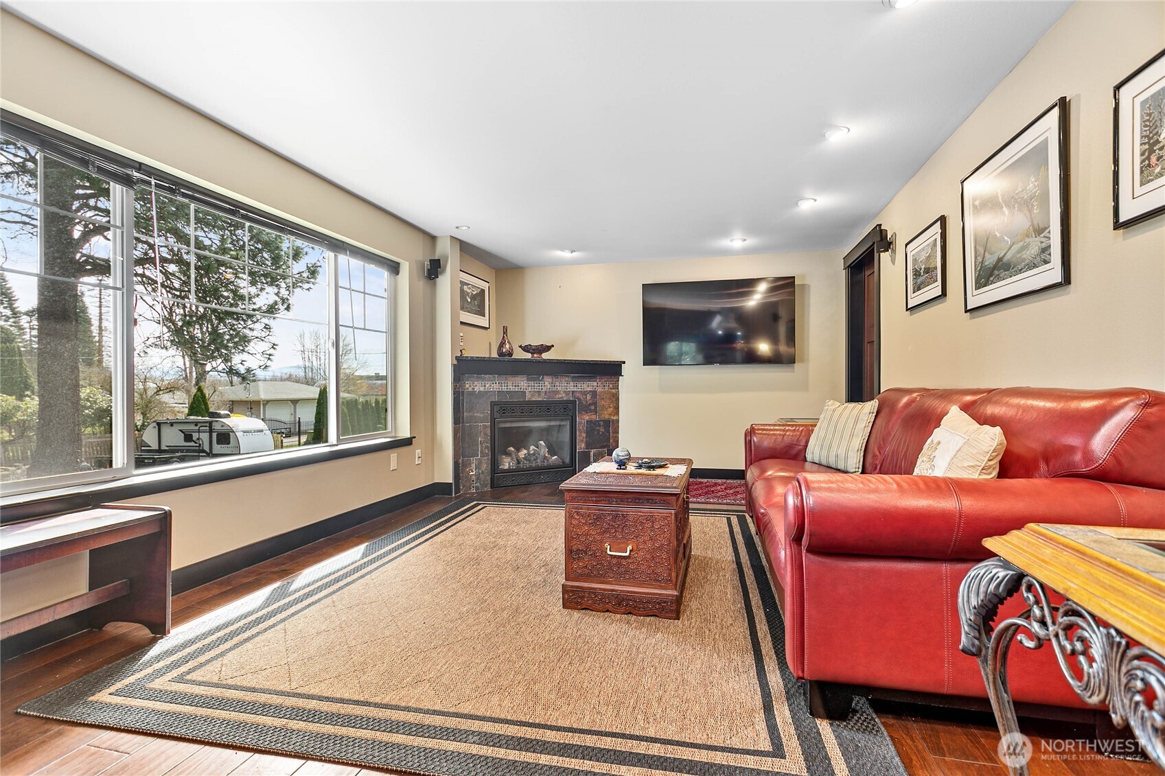 1082 West Smith Road Bellingham, WA 98226 - Photo 9 of 38 a living room with furniture a flat screen tv and a large window