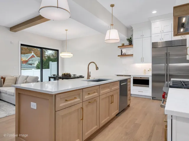a kitchen with cabinets a sink and appliances
