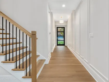 a view of a hallway with wooden floor and entryway