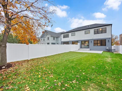 a front view of a house with yard and green space