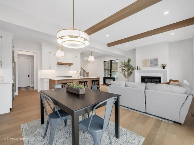 a living room with furniture a fireplace and a table