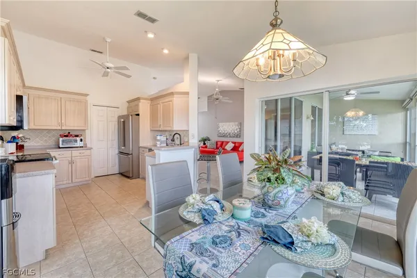 a living room with kitchen island furniture and a chandelier