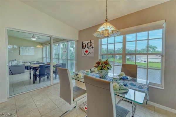 a dining room with furniture a chandelier and window
