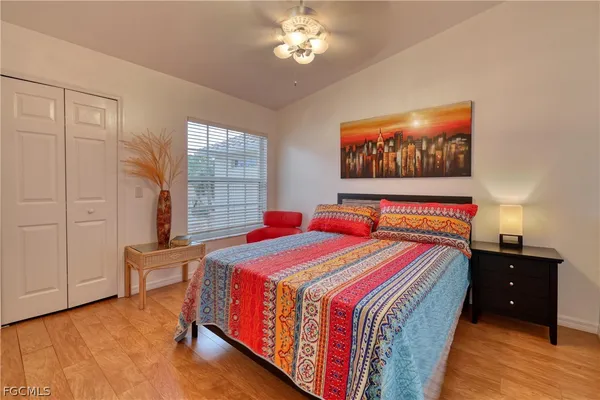 a bedroom with a bed and a chandelier