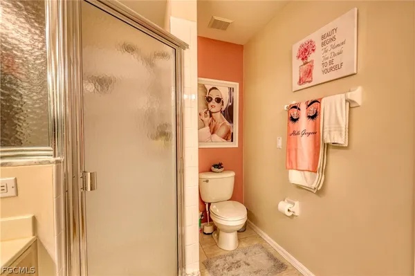 a bathroom with a toilet and a shower curtain