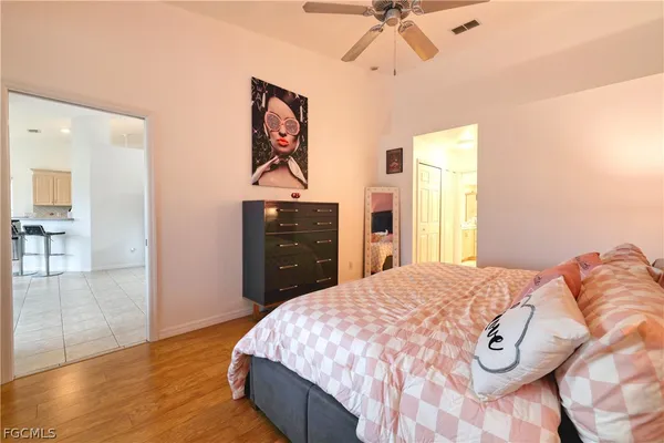 a bedroom with a bed and a chandelier