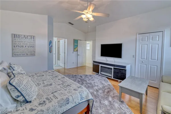 a bedroom with a bed and a flat screen tv