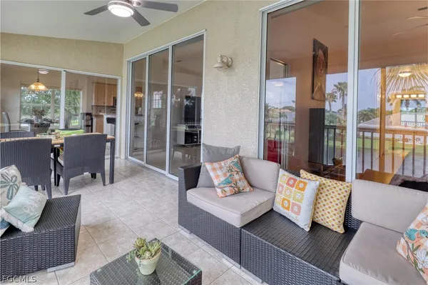 a living room with furniture and large window