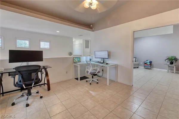 a work room with furniture and a flat screen tv