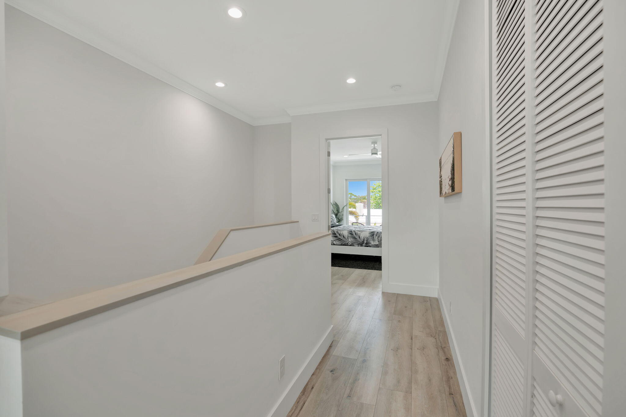 4680 Southeast Manatee Terrace Stuart, FL 34997 - Photo 20 of 34 a view of a hallway to a livingroom with wooden floor a fireplace and a window