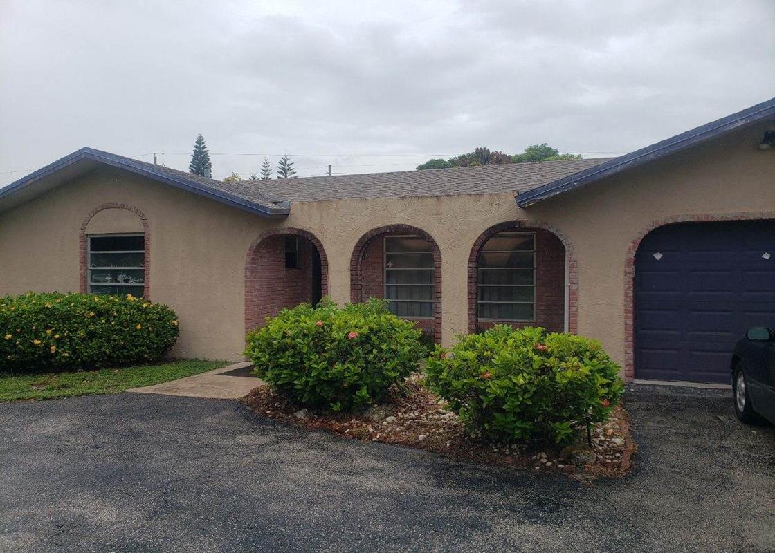 a view of a house with a yard and plants