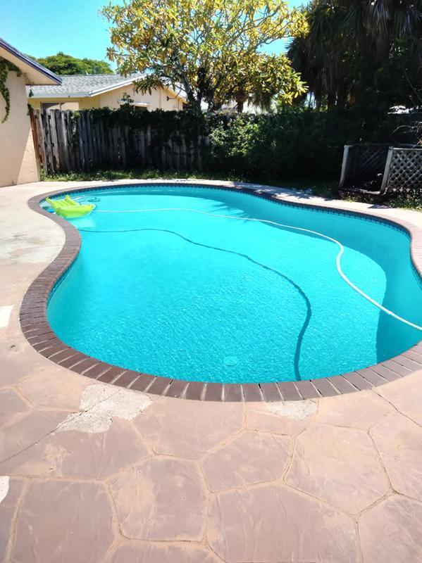 4663 Northeast 4th Avenue Boca Raton, FL 33431 - Photo 3 of 6 a view of a swimming pool with a backyard