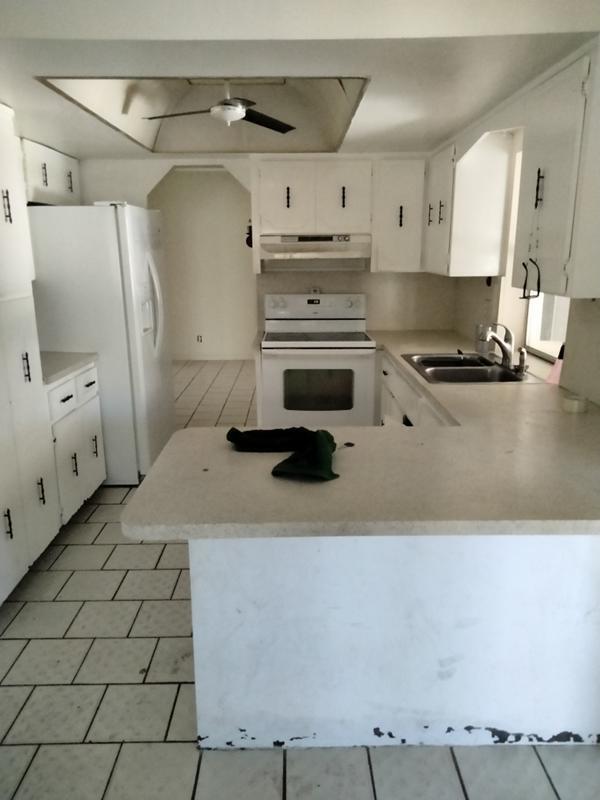 4663 Northeast 4th Avenue Boca Raton, FL 33431 - Photo 4 of 6 a kitchen with a stove a white cabinet and a sink