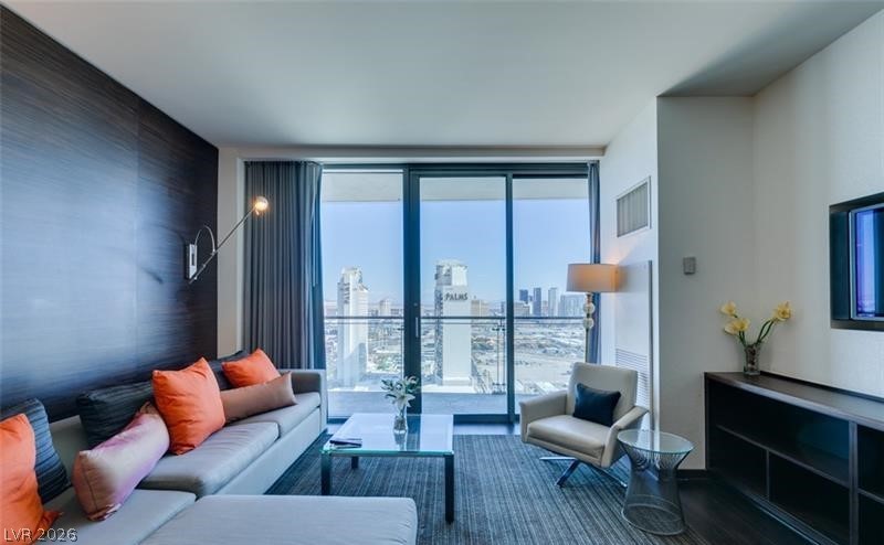 4381 West Flamingo Road, Unit 15310 Las Vegas, NV 89103 - Photo 11 of 52 Living room featuring visible vents and floor to ceiling windows