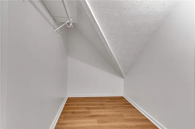 a view of a room with wooden floor and white walls