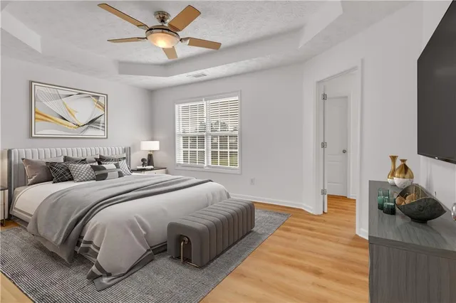 a bedroom with bed and a chandelier