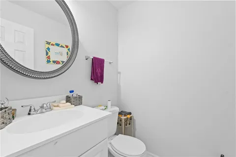 a bathroom with a sink a mirror and a toilet