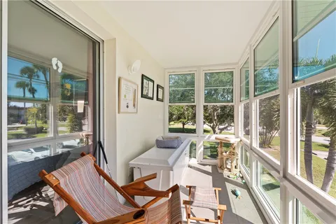 a view of a living room with a large window and furniture