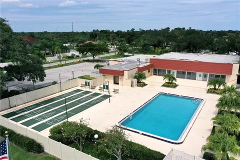a aerial view of a house with a yard table and chairs