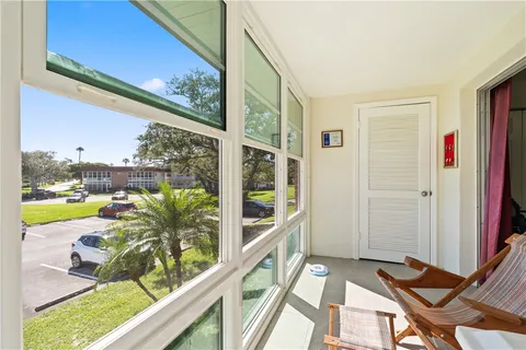 a view of a balcony with lake view and wooden floor