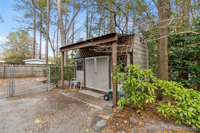 front view of a house with a yard and potted plants