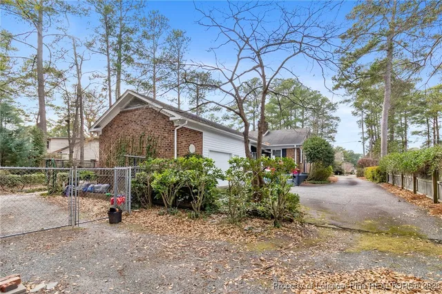 a view of a house with a yard and potted plants