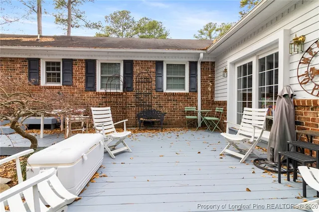 a view of a patio with a table and chairs and potted plants