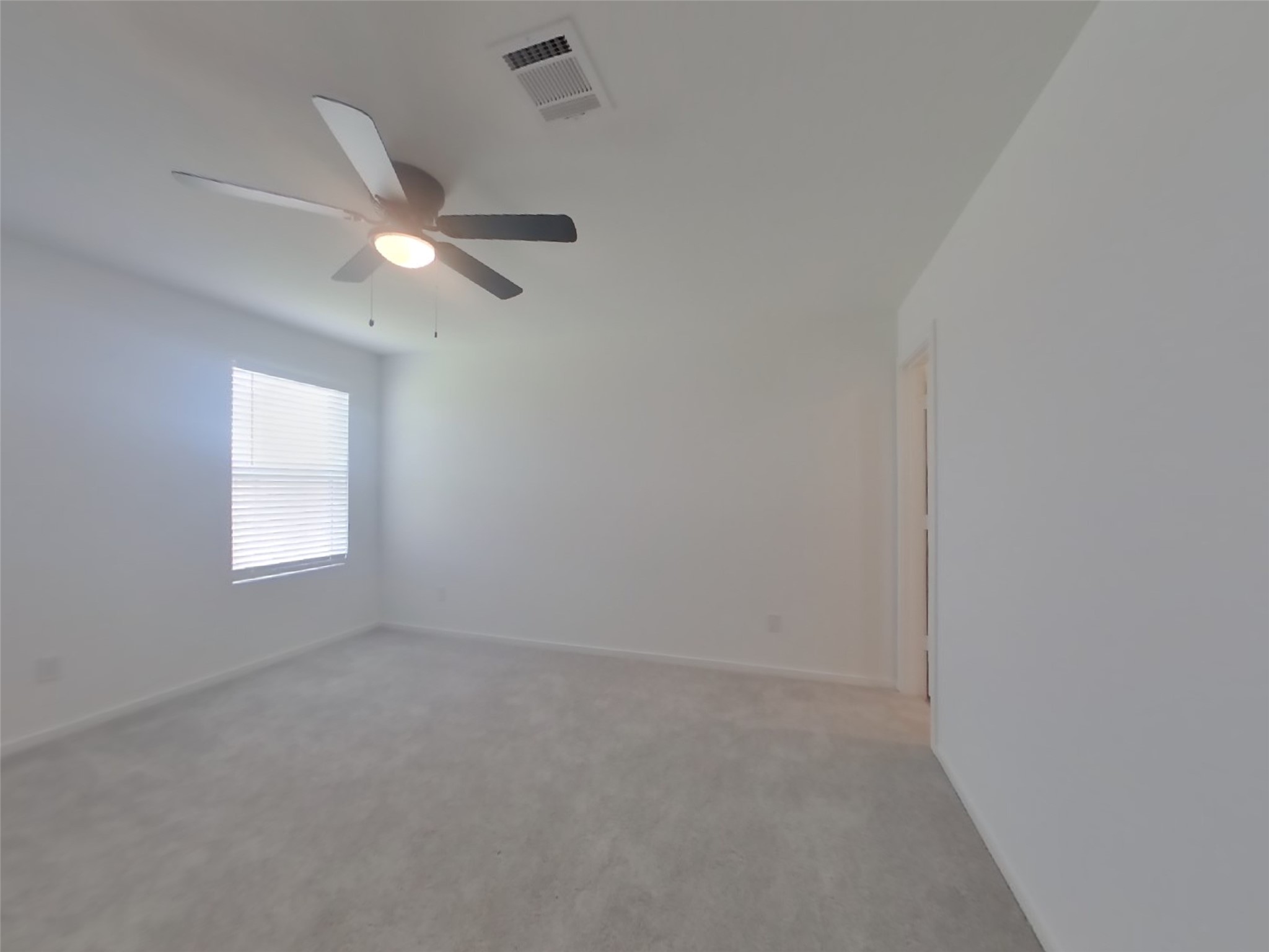 3009 Merganser Ridge Drive Katy, TX 77493 - Photo 5 of 18 an empty room with a window and ceiling fan