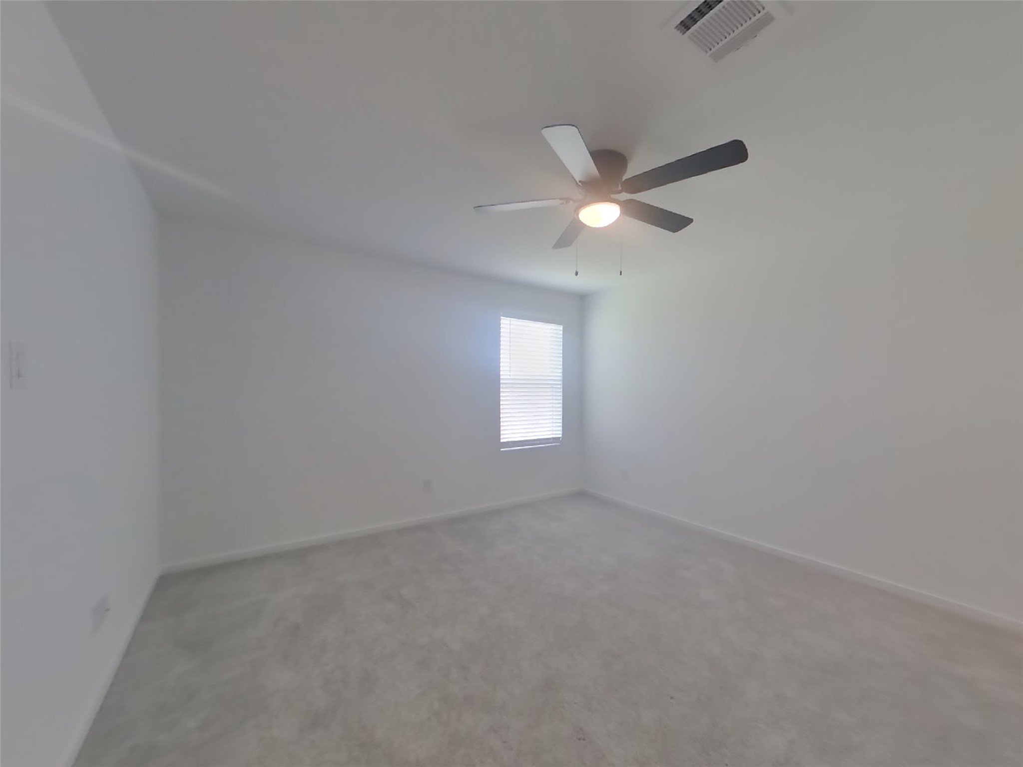 3009 Merganser Ridge Drive Katy, TX 77493 - Photo 6 of 18 an empty room with a window and a fan