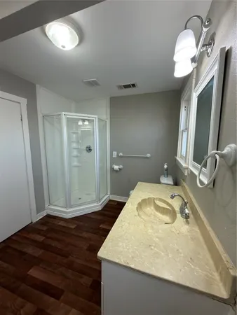 a bathroom with a granite countertop sink and a mirror