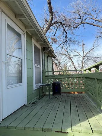 a view of a yard with wooden fence
