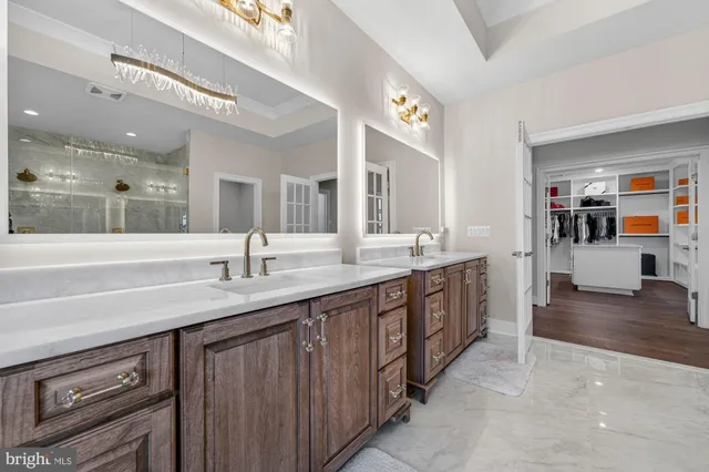 a bathroom with a sink a toilet and a large mirror