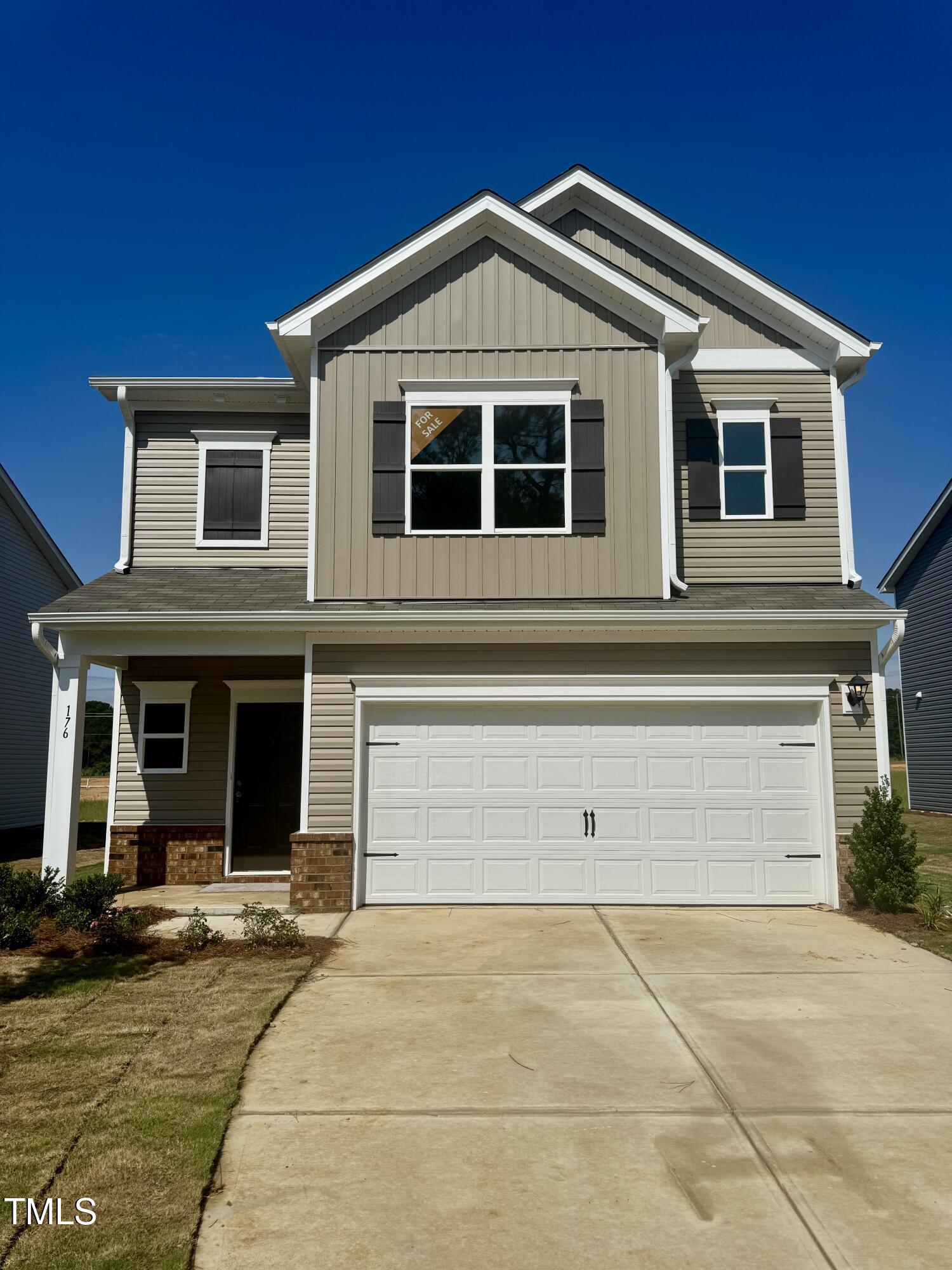 a front view of a house with garage
