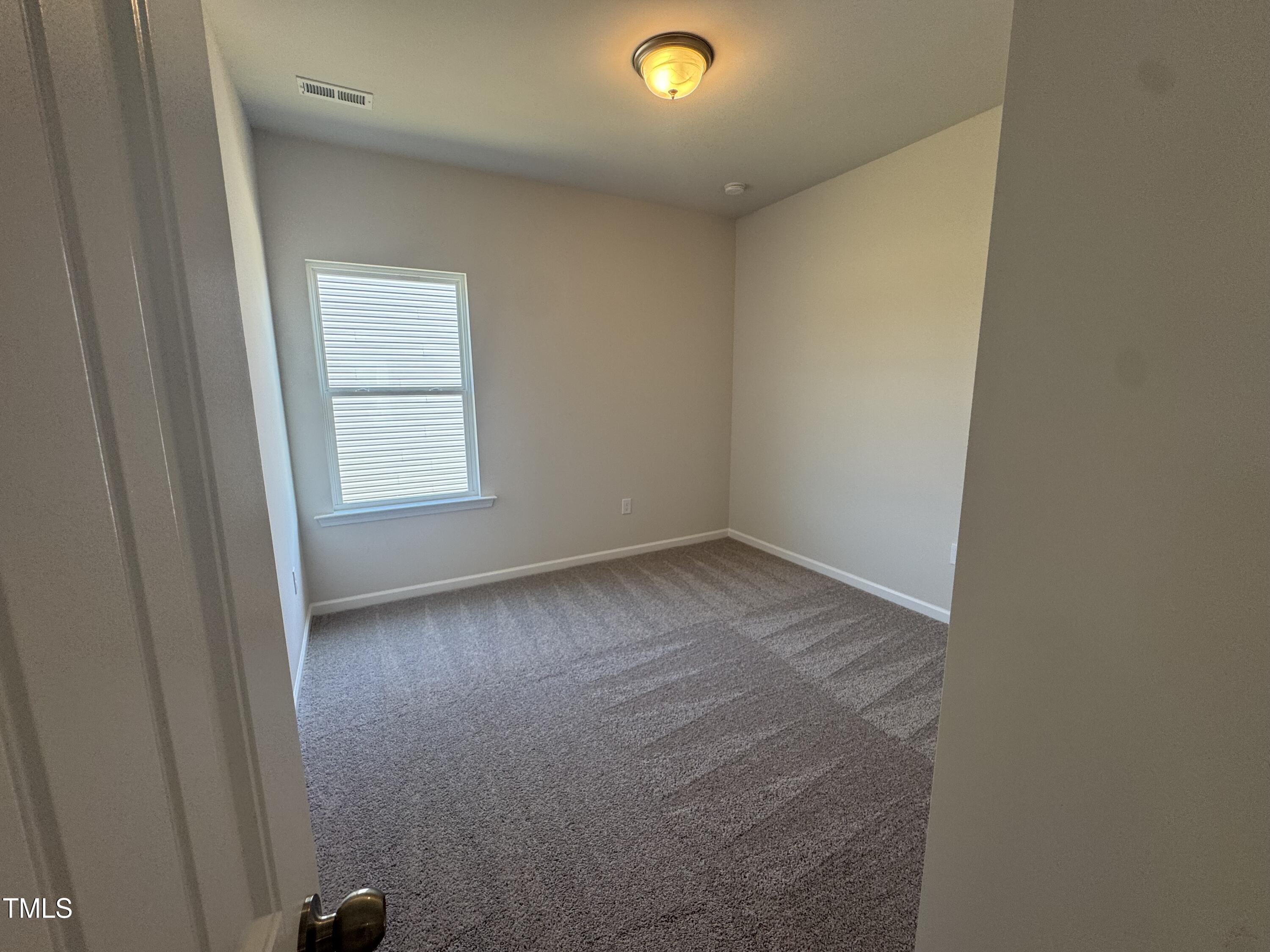 176 Bruce Drive Dunn, NC 28334 - Photo 22 of 30 an empty room with a window