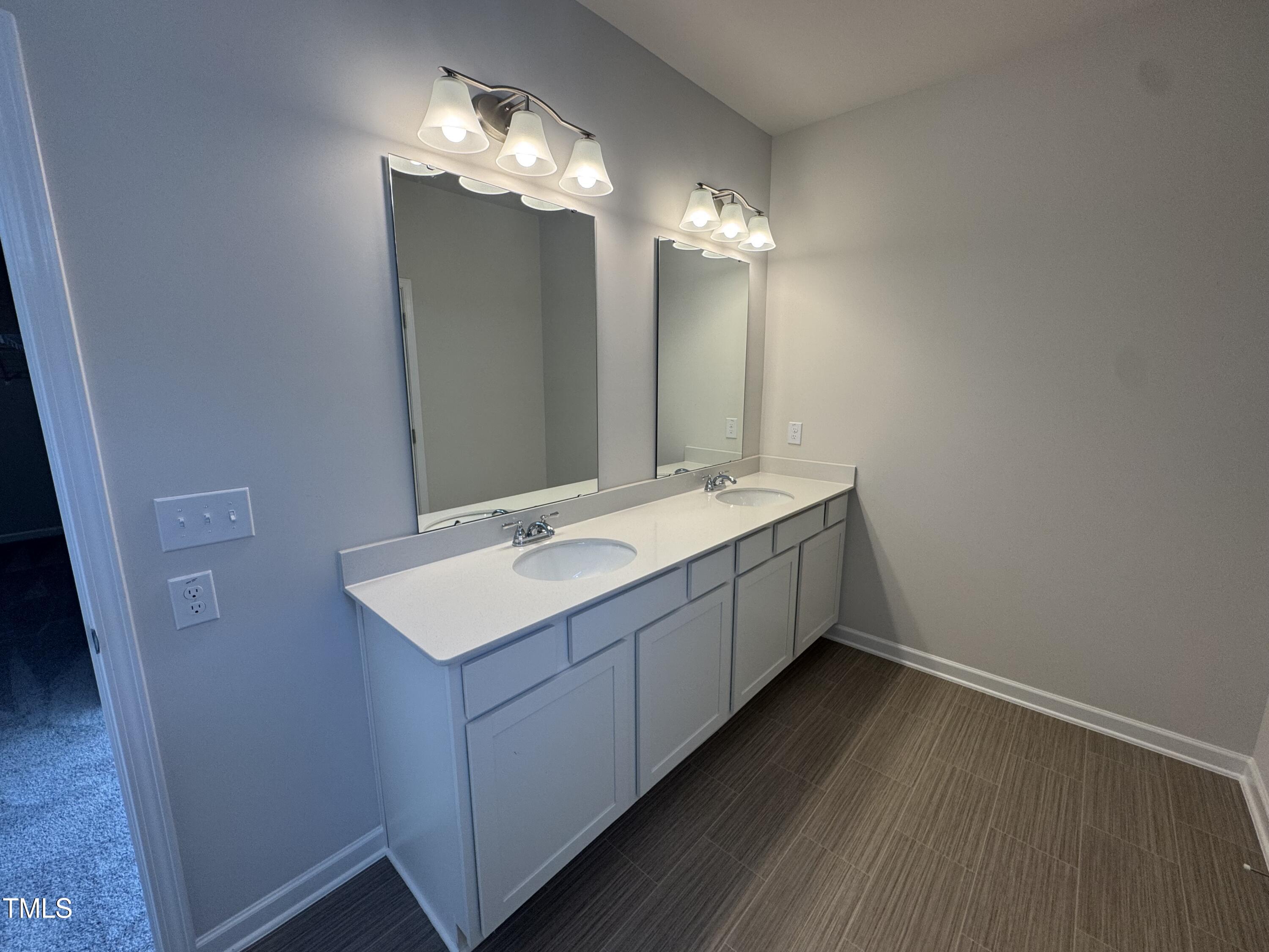 176 Bruce Drive Dunn, NC 28334 - Photo 29 of 30 a bathroom with a sink and a mirror