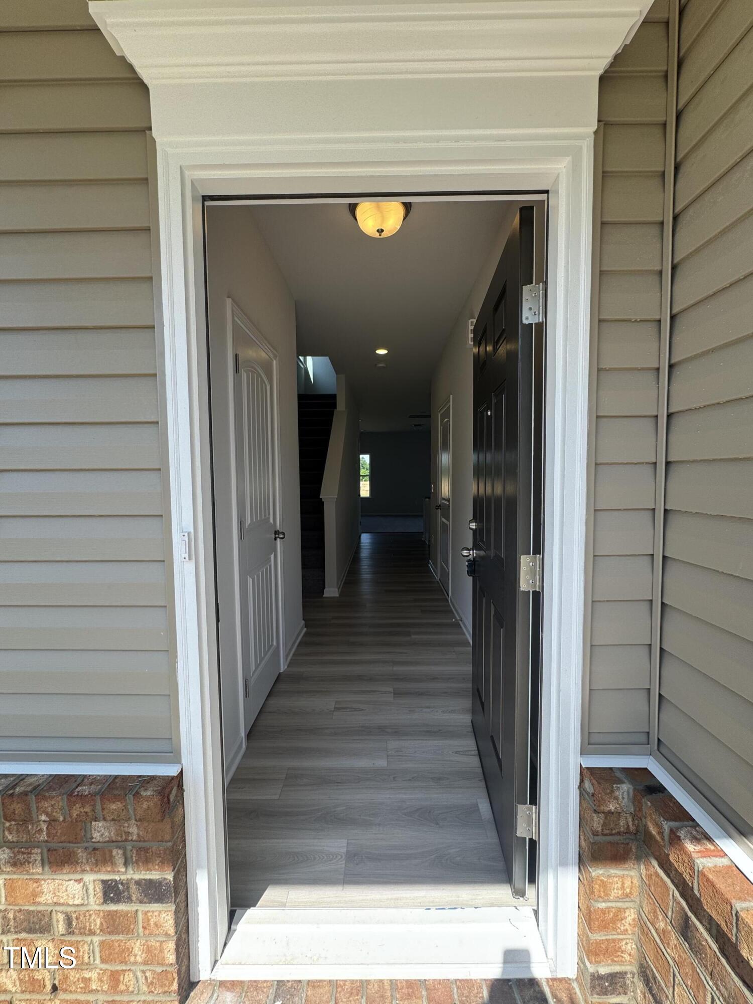 176 Bruce Drive Dunn, NC 28334 - Photo 3 of 30 a view of a hallway with wooden floor and staircase