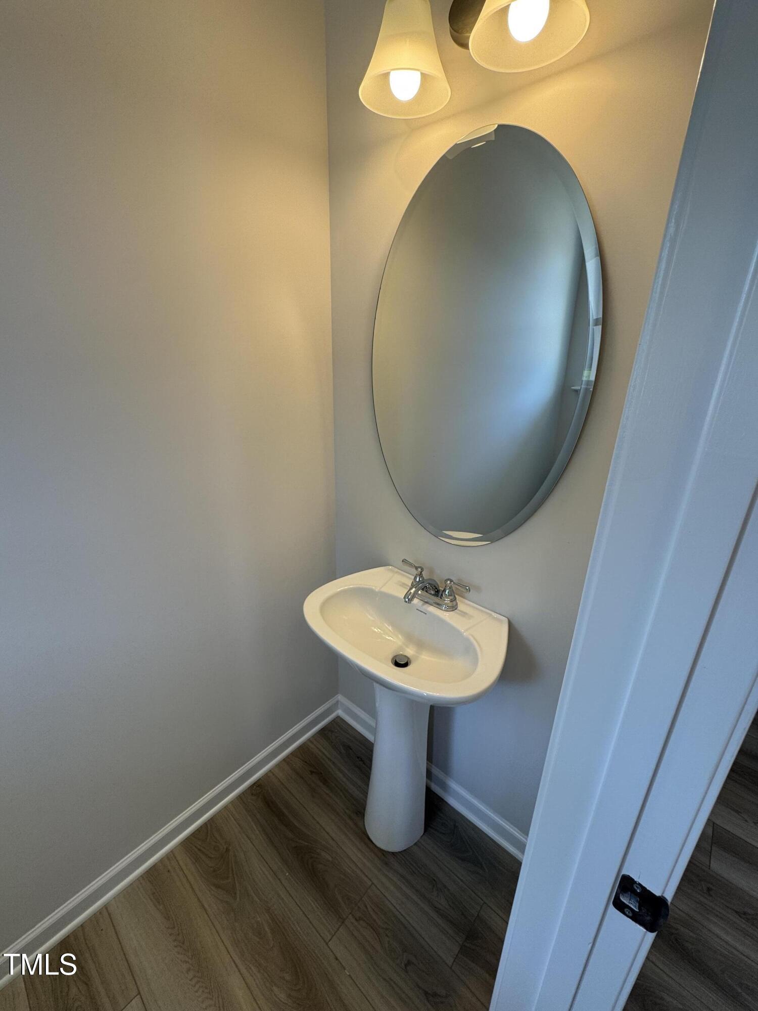 176 Bruce Drive Dunn, NC 28334 - Photo 5 of 30 a bathroom with a sink and mirror