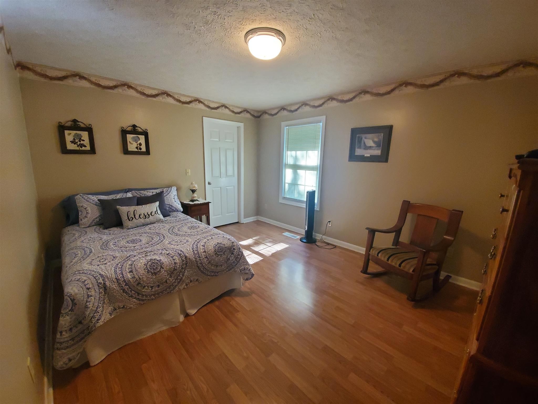 1074 A North Corinth Road Portland, TN 37148 - Photo 16 of 25 a bedroom with a bed and wooden floor