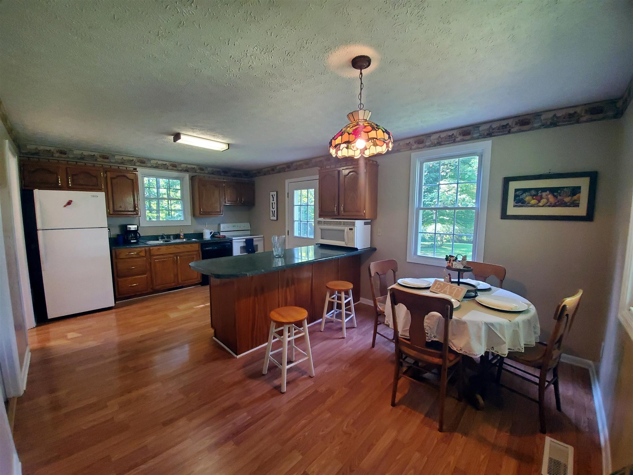 1074 A North Corinth Road Portland, TN 37148 - Photo 7 of 25 a view of a dining room with furniture window and wooden floor