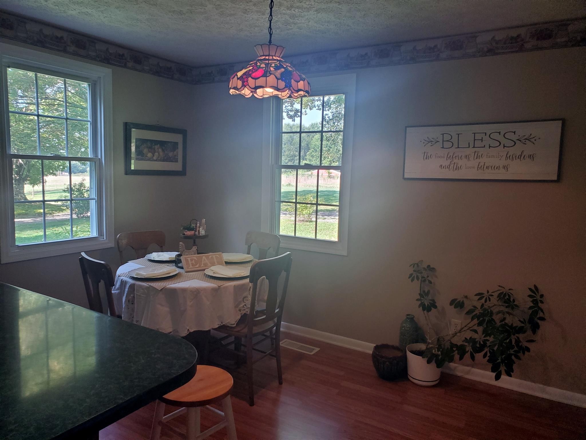 1074 A North Corinth Road Portland, TN 37148 - Photo 8 of 25 a dining room with furniture a potted plant and wooden floor