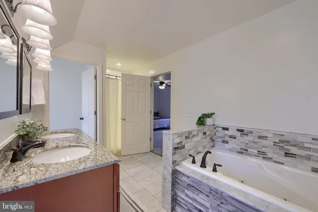 a spacious bedroom with a bed couch and window