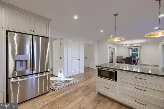 a kitchen with stainless steel appliances granite countertop a sink a stove and a refrigerator