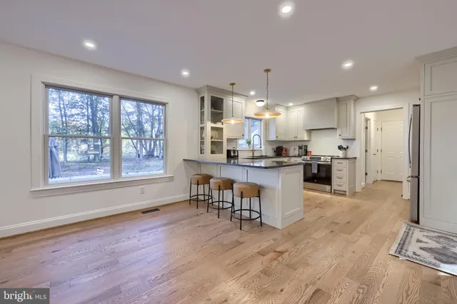 a kitchen with chairs and refrigerator