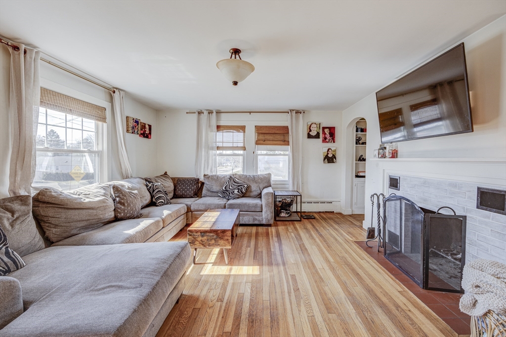 707 Hathaway Road New Bedford, MA 02740 - Photo 12 of 33 a living room with fireplace furniture and a flat screen tv