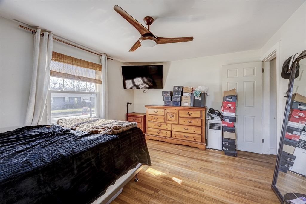 707 Hathaway Road New Bedford, MA 02740 - Photo 18 of 33 a bedroom with bed and wooden floor