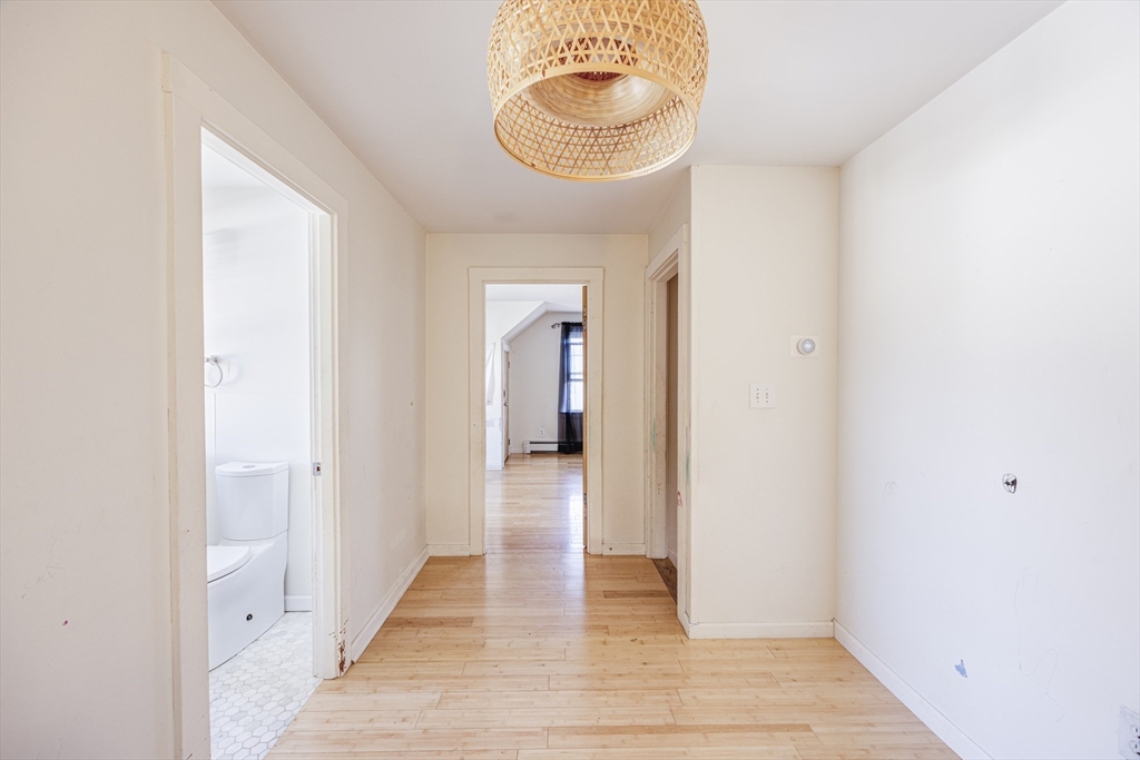 707 Hathaway Road New Bedford, MA 02740 - Photo 20 of 33 a view of a hallway with wooden floor